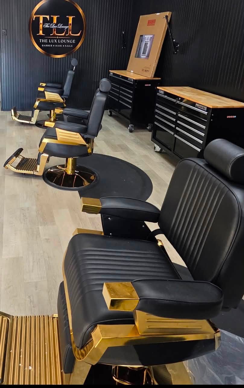 The Lux Lounge barber area with black and gold chairs